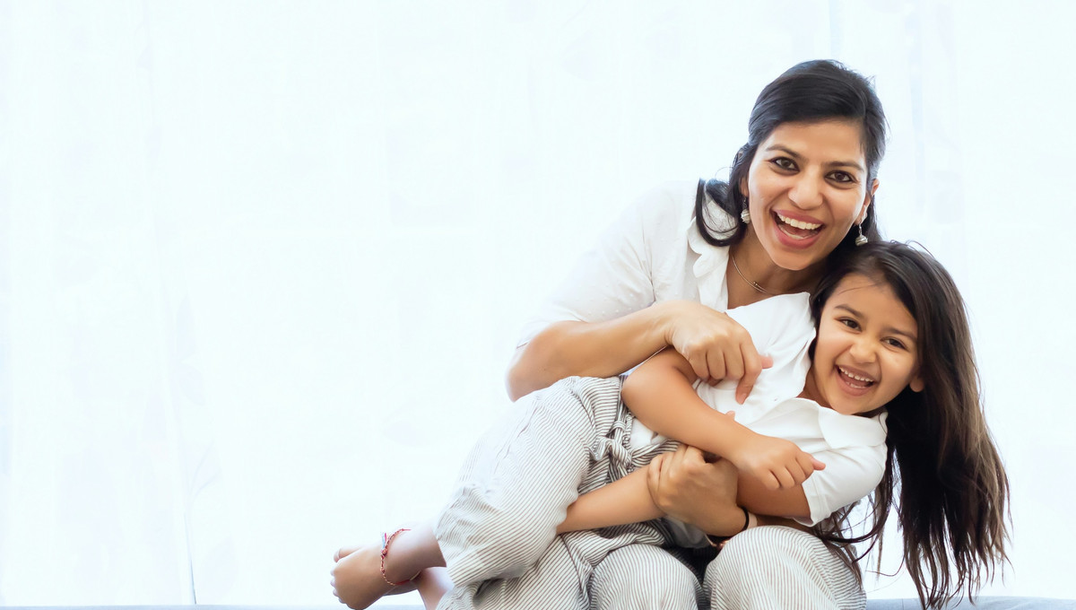 Mother and daughter relaxing in a comfortable home