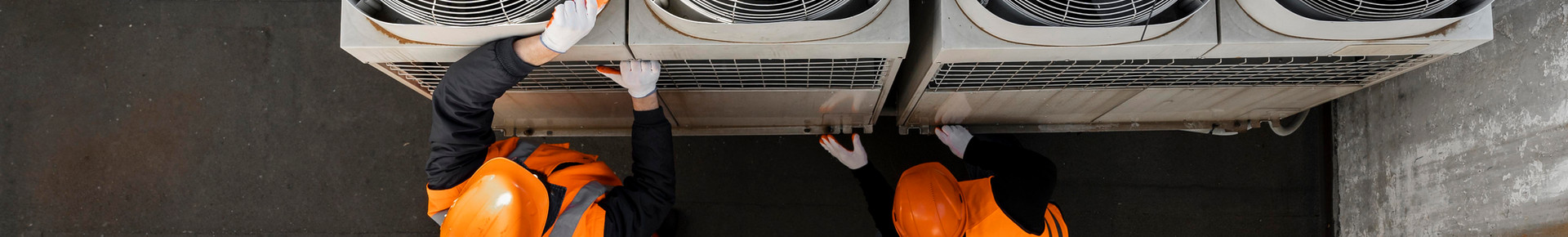 HVAC technicians installing air conditioning equipment